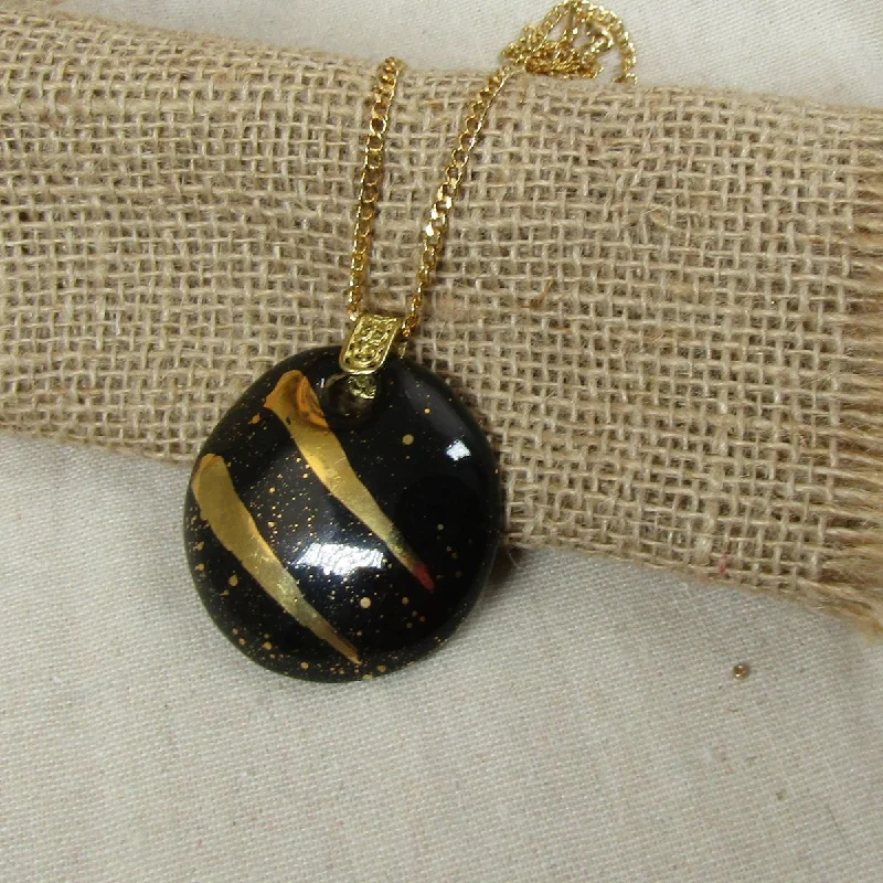 Layered necklaces and pendants for a trendy and fashionable stacked look-Black and Gold Large Fair Trade  Kazuri Pendant Necklace